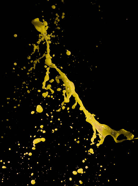 istock splashes of yellow paint isolated on black background 487451586