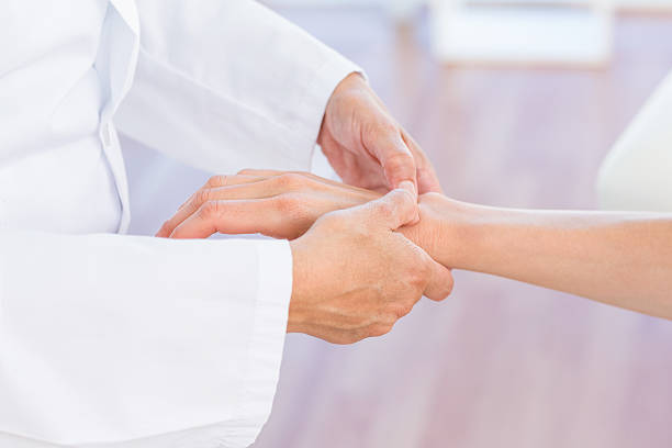 istock Doctor examining her patients wrist 487451736