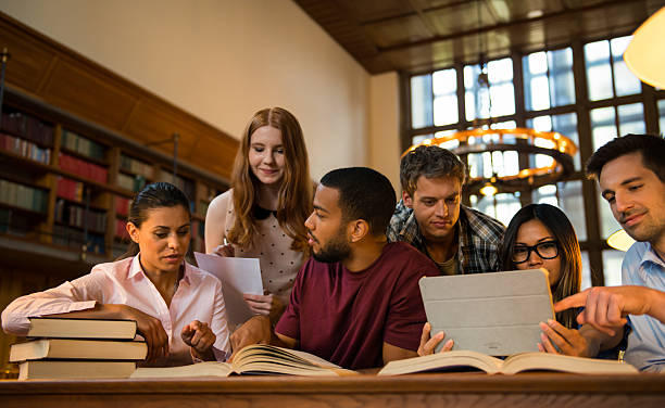 istock Group Of Young Student In Library 487452860
