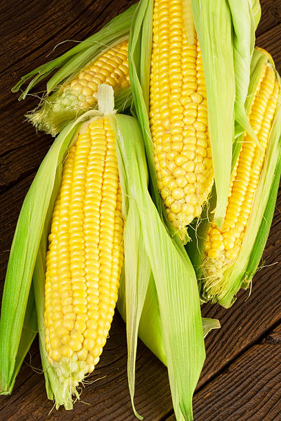istock Sweetcorn on Wooden Background 487453026