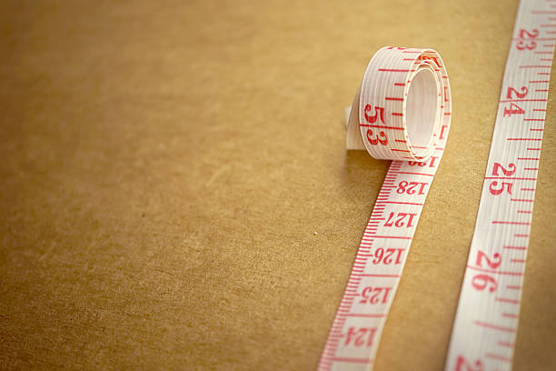 istock Measuring tape on craft paper for background (diet concept) 487453102