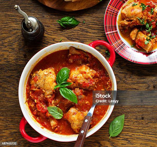 Baked Rabbit In Tomato Sauce With Rosemary And Basil Stock Photo - Download Image Now