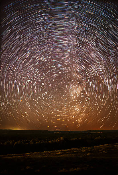 istock beautiful night sky, Milky Way, star trails  and the trees 487456338