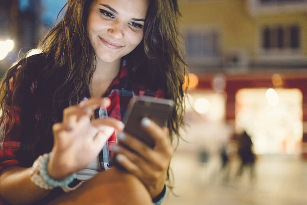Girl texting on smartphone outside