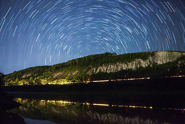 istock beautiful night sky, Milky Way, star trails  and the trees 487457482