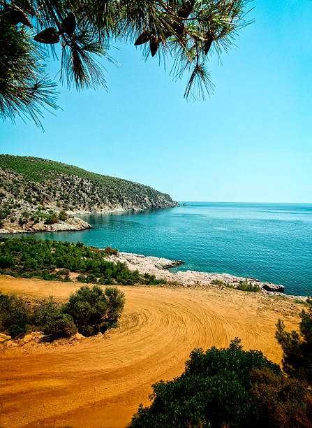 Small private bay on isle of Thassos with red dirt road to it