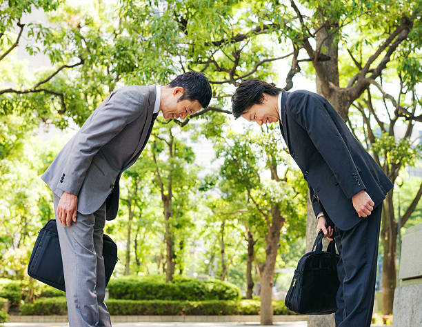 Japanese businessmen bowing to each other