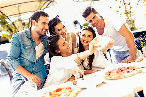 istock Group of young beautiful people sitting in a restaurant 487462532