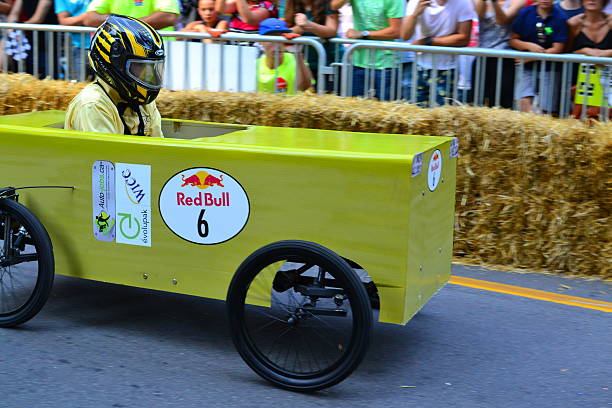 Montreal Red Bull Soapboax Race Montreal, Canada - September 06, 2015: Montreal Red Bull Soapboax Race in Montreal Downtow.A lot of fun and ingenious ideas.Number 6-Green box team. red bull mini stock pictures, royalty-free photos & images