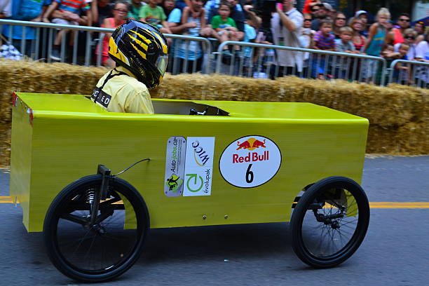 Montreal Red Bull Soapboax Race  Montreal, Canada - September 06, 2015: Montreal Red Bull Soapboax Race in Montreal Downtow.A lot of fun and ingenious ideas.Number 6-Green box team. red bull mini stock pictures, royalty-free photos & images