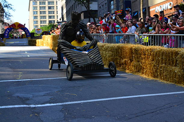 Montreal Red Bull Soapboax Race Montreal, Canada - September 06, 2015: Montreal Red Bull Soapboax Race in Montreal Downtow.A lot of fun and ingenious ideas..Number 8- Wood monster team. red bull mini stock pictures, royalty-free photos & images