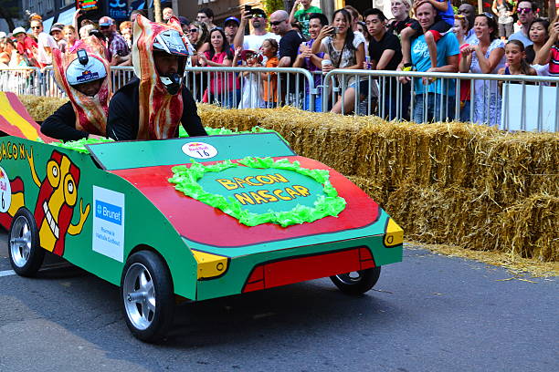 Montreal Red Bull Soapboax Race Montreal, Canada - September 06, 2015: Montreal Red Bull Soapboax Race in Montreal Downtow.A lot of fun and ingenious ideas.Number 16-Bacon NASCAR team. red bull mini stock pictures, royalty-free photos & images