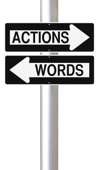 Modified one way street signs indicating Actions and Words