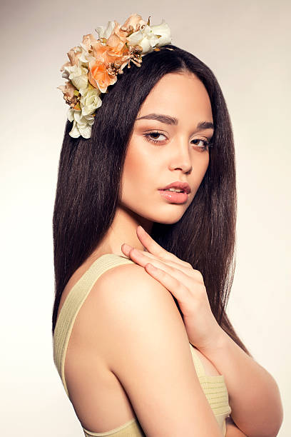 istock beautiful glamour brunette with flower's headband 487464073