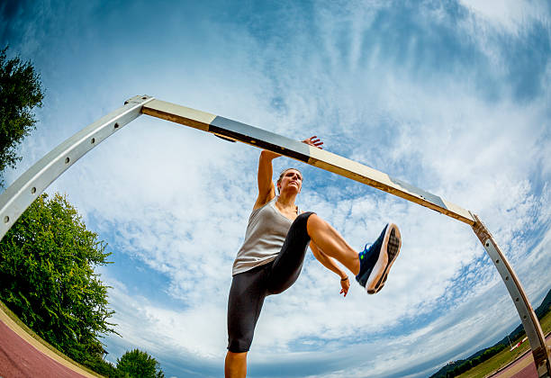 istock Female competitor jumping the steeplechase obstacle 487464239