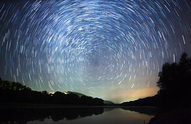 istock beautiful night sky, Milky Way, star trails  and the trees 487464650