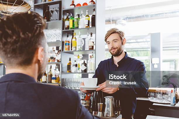 Barman Serving Coffee In A Pub Stock Photo - Download Image Now - 2015, Adult, Adults Only