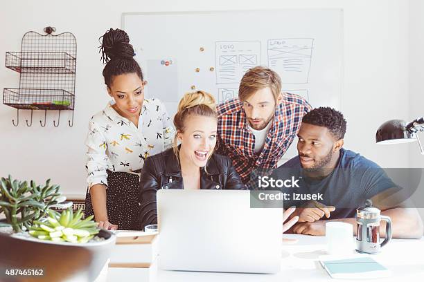 Startup Agency Excited Multi Ethnic Group Using Laptop Stock Photo - Download Image Now