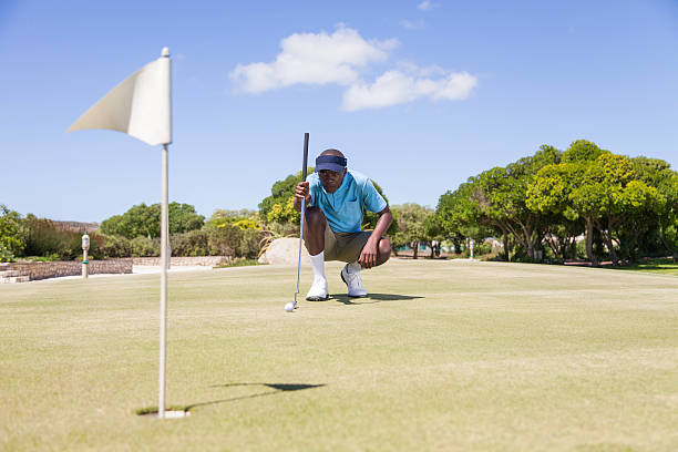 istock African golfer aiming to make his next putt perfect. 487465249
