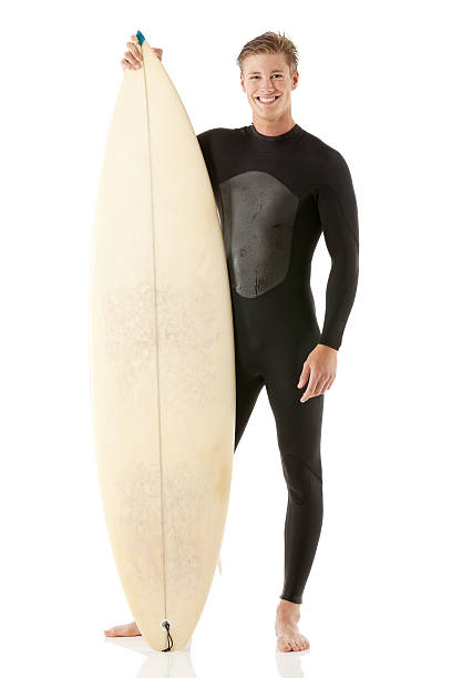 istock Cheerful young man holding Surfboard 487465413