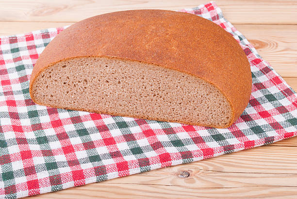 istock Loaf of bread on a wooden table. 487465571
