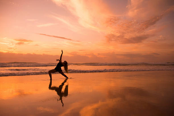 istock Girl posing in a beautiful dance pose on beach 487465724