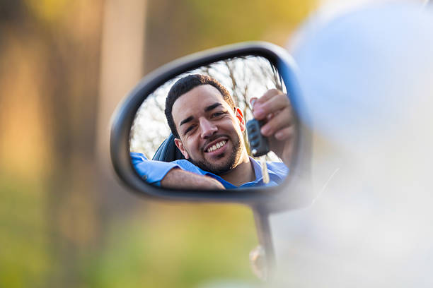 istock Young latin american driver holding car keys driving his n 487465929