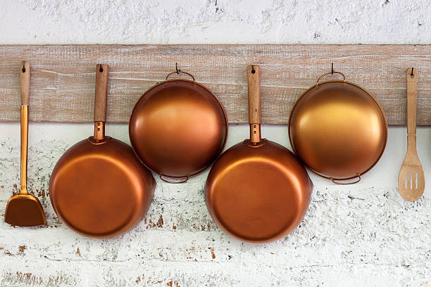 Copper kitchen utensil Copper kitchen utensil on the white painted brick wall copper wall stock pictures, royalty-free photos & images