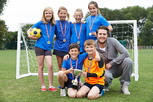 istock Victorious School Soccer Team With Medals And Trophy 487466332