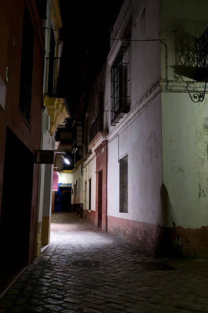 Dark Alleyway in Santa Cruz district of Seville stock photo