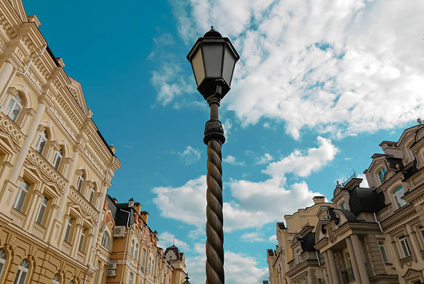 Vintage street lantern against blue cloudy sky