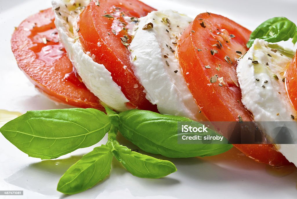 Caprese Salad Caprese Salad. Tomato and Mozzarella slices with basil leaves. Appetizer Stock Photo