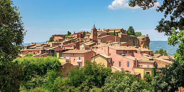 View to the idyllic village of Roussillon, famous for its large and colorful ochre deposits. Roussillon, Provence-Alpes-Cote d'Azur, France.