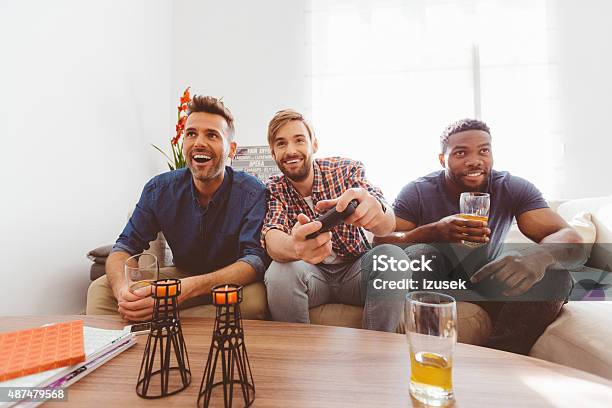 Three Guys Playing Video Games Stock Photo - Download Image Now - Beer - Alcohol, Men, Sofa