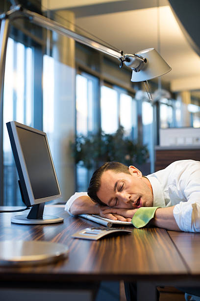 istock Exhausted businessman sleeping at his desk 487479636