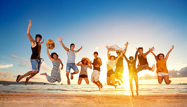 Group of friends jumping on beach, concept fun jump