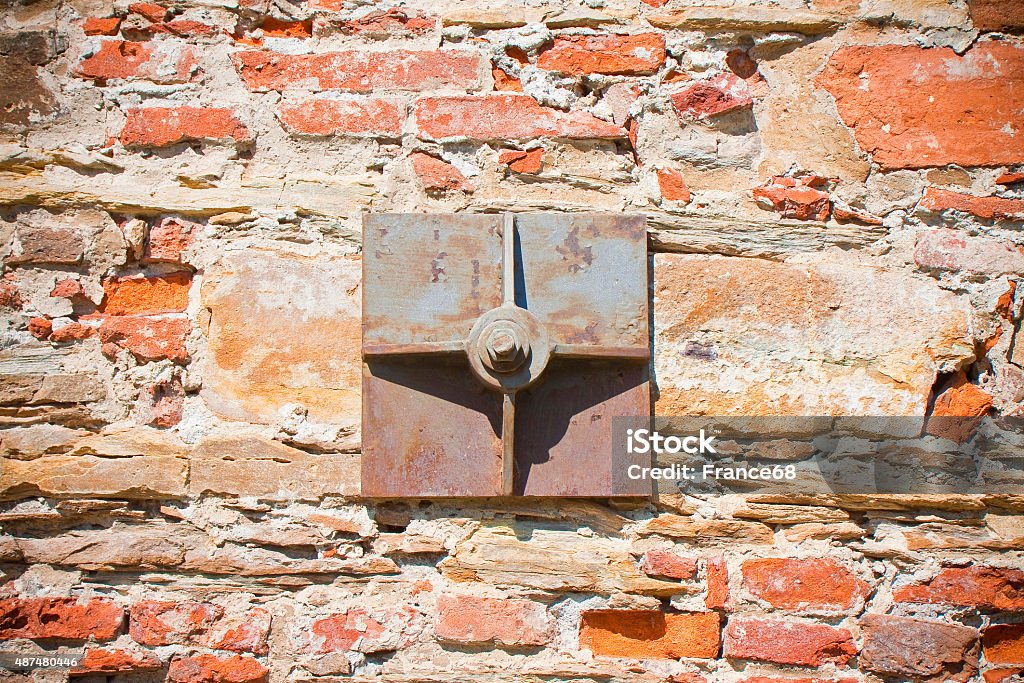 Old brick wall reinforced with metal plates 2015 Stock Photo