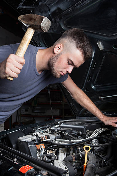 istock Crazy mechanic car repair engine motor hammer 487480882
