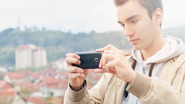 istock Teenage boy with mobile phone 487485301
