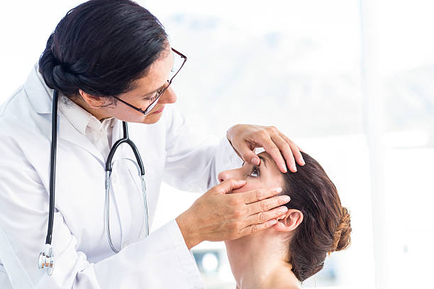 Doctor checking her patients eyes