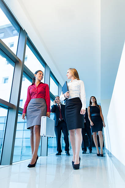 istock Two business women walking down the hall and talking 487488739