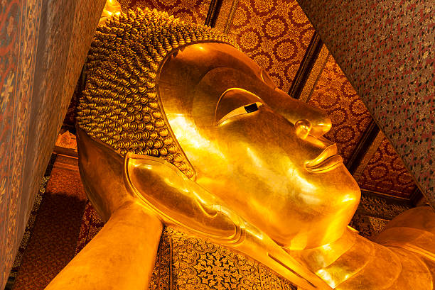 istock Reclining Buddha gold statue face. Wat Pho, Bangkok, Thailand 487489029
