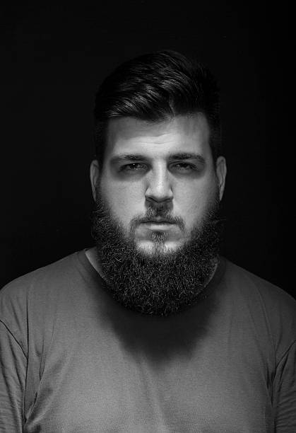istock Bored mysterious male portrait. Low key, black background. 487489116