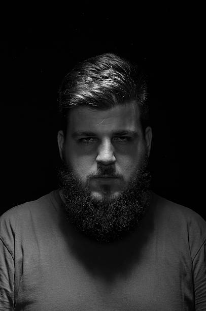 istock Bored mysterious male portrait. Low key, black background. 487489122