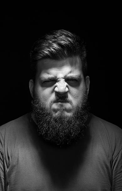 istock Very angry, and aggressive male portrait. Black background, low 487489130