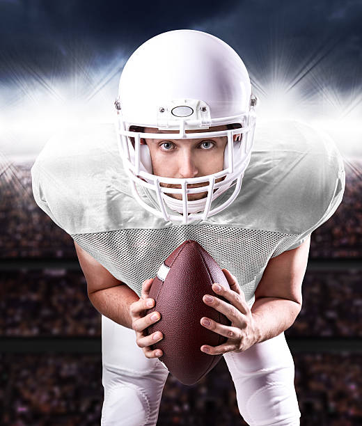 istock Football Player on white uniform in the stadium 487489630
