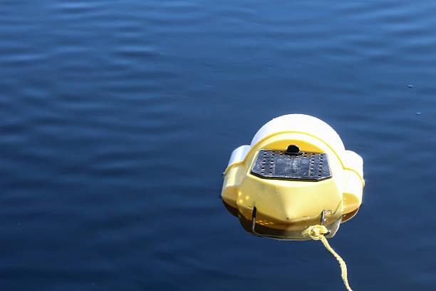 istock Yellow minnow bait bucket floating in blue water 487489892