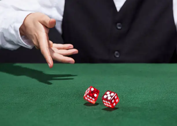 Photo of Croupier throwing a pair of dice