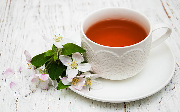 istock Cup of tea and spring blossom 487490590