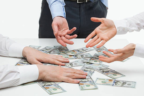 istock Business people dividing money 487498786